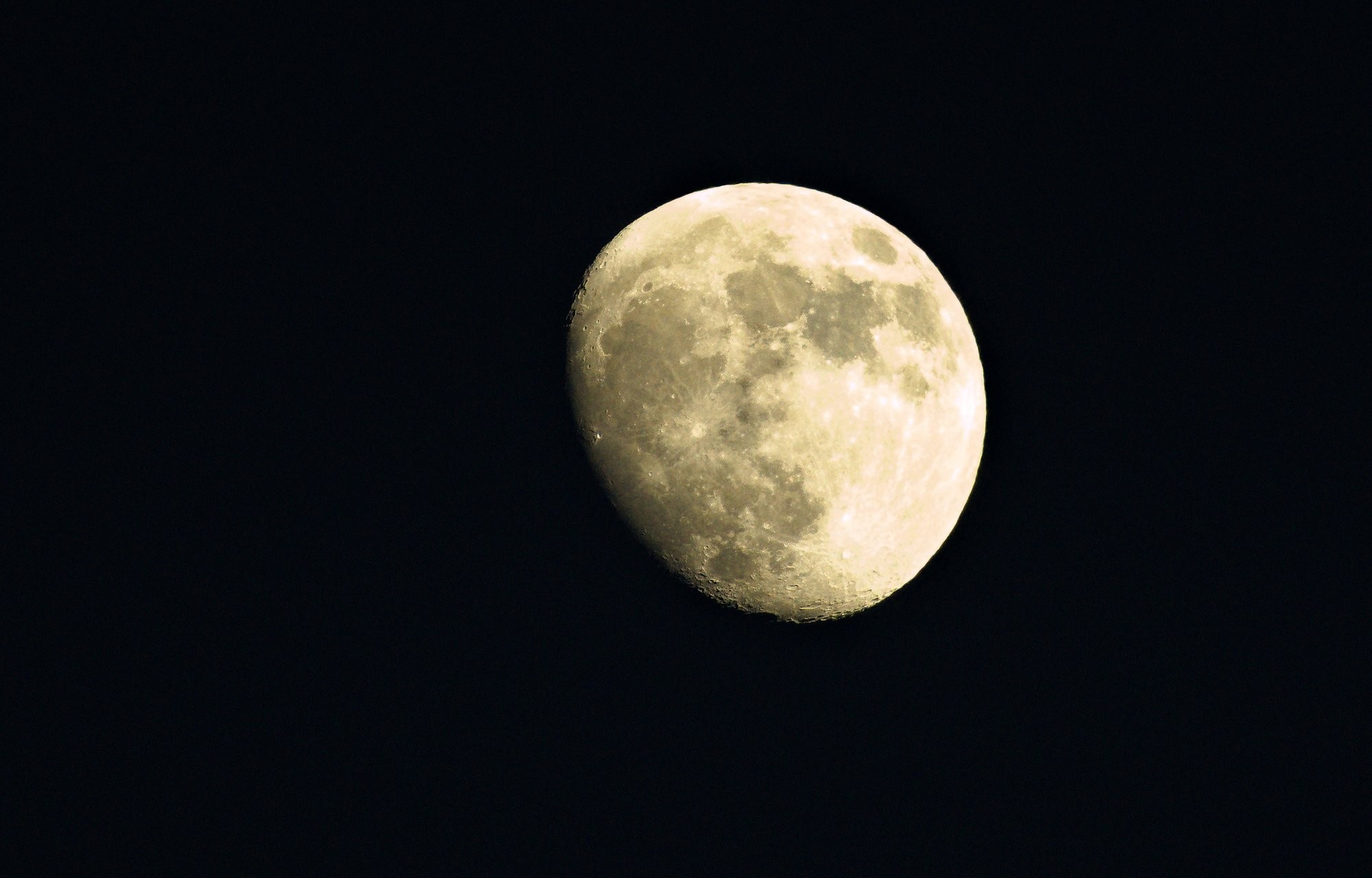 A picture of the moon, not full, in a black sky. Visible are the craters.